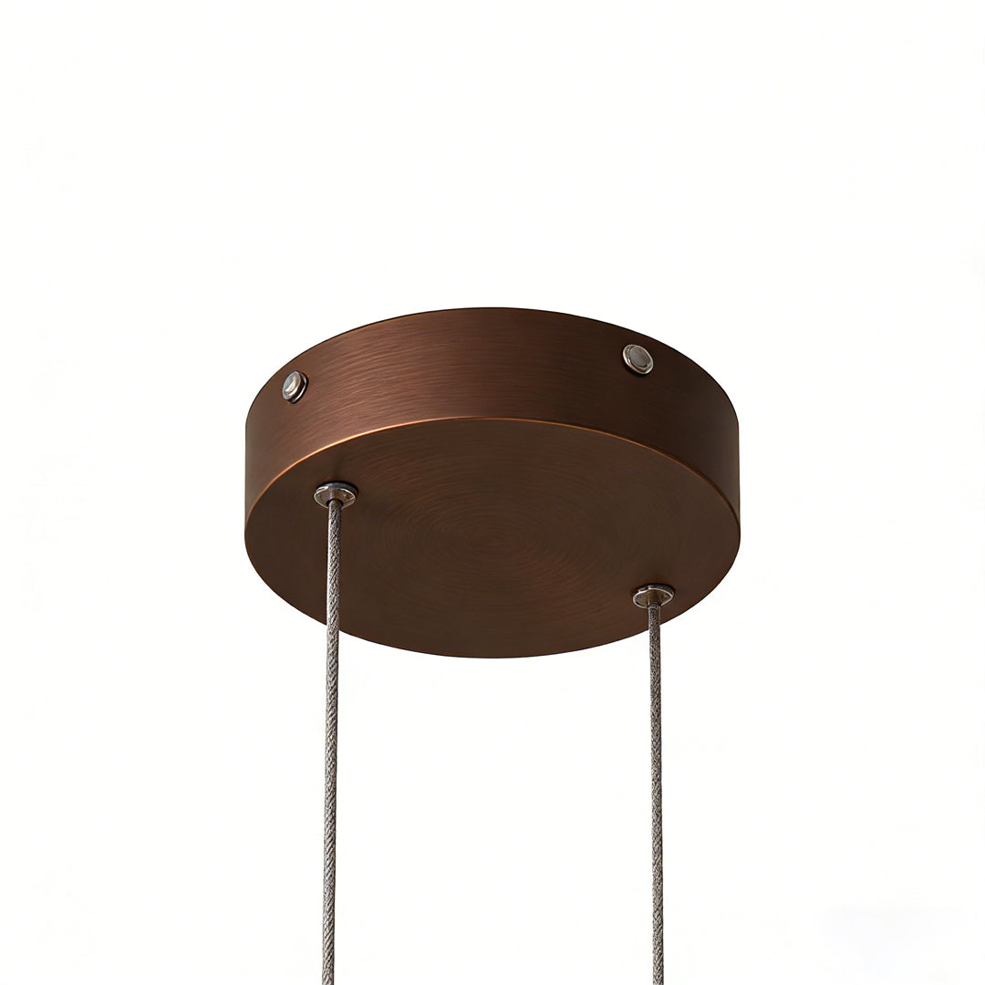 Close-up of linear pendant light fixture canopy and suspension cables.