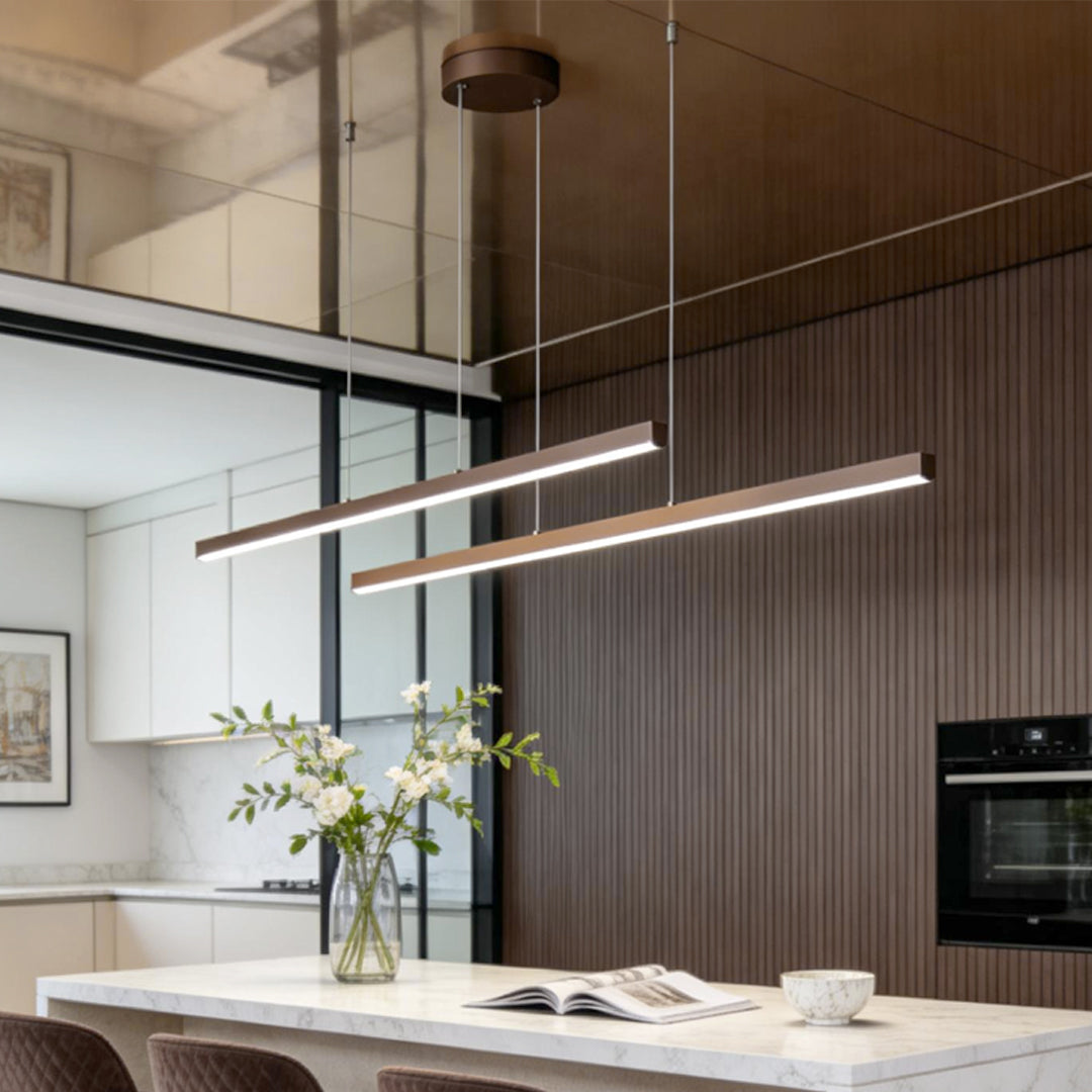 Linear pendant light fixture installed above modern kitchen island.