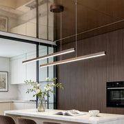 Linear pendant light fixture installed above modern kitchen island.