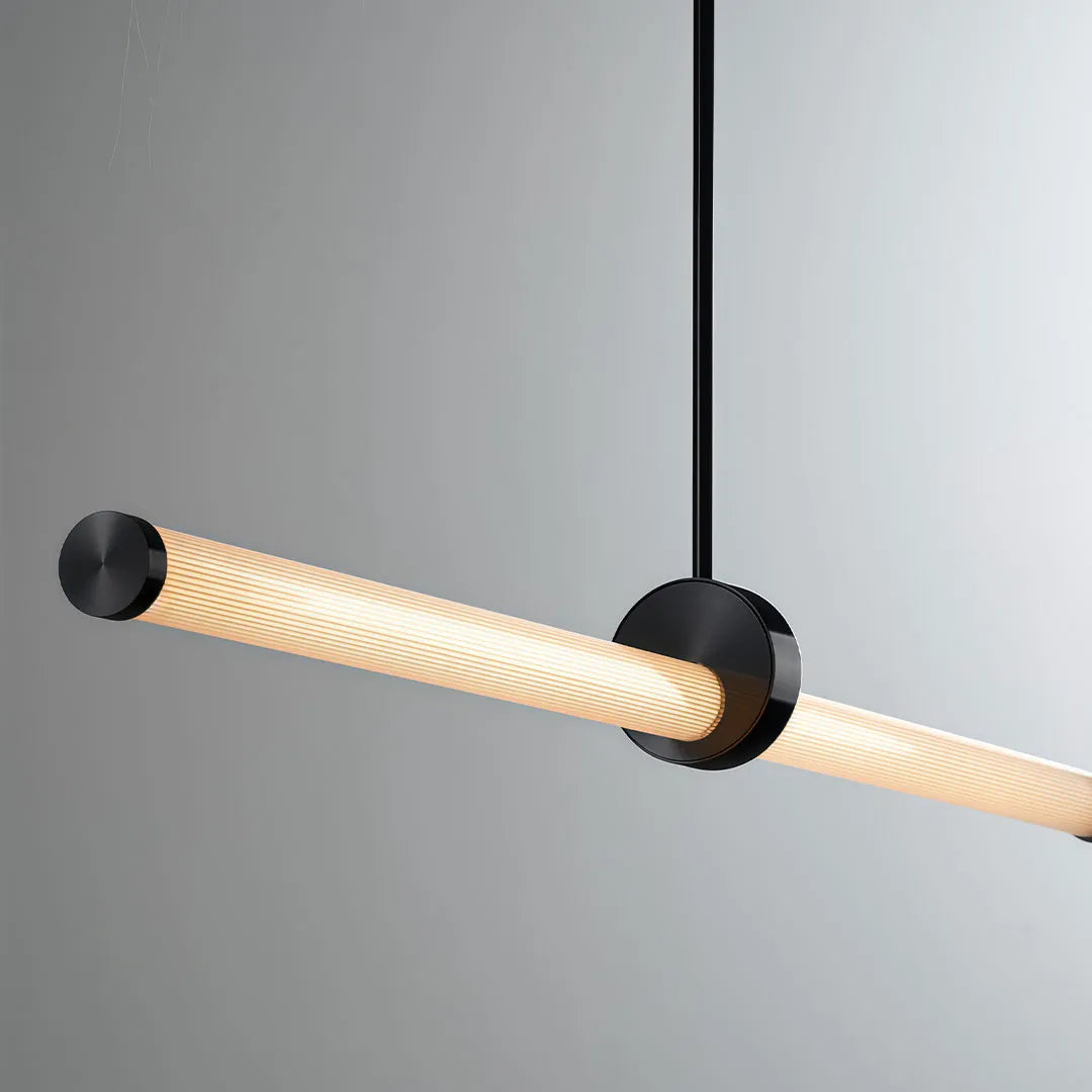 Linear pendant lights with a slim illuminated tube and central black suspension mount.