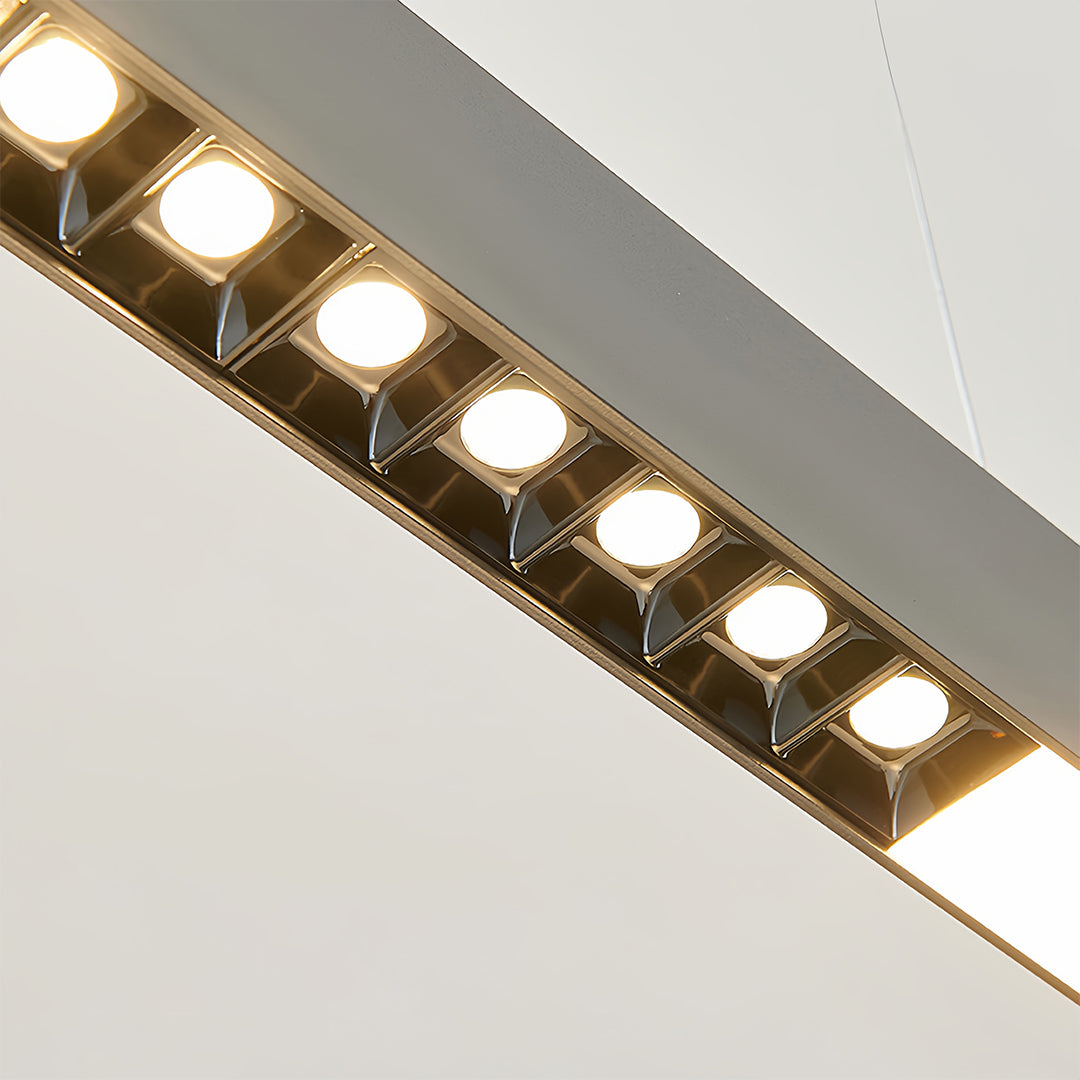 Linear light pendant with warm LED illumination creating ambient lighting in contemporary office