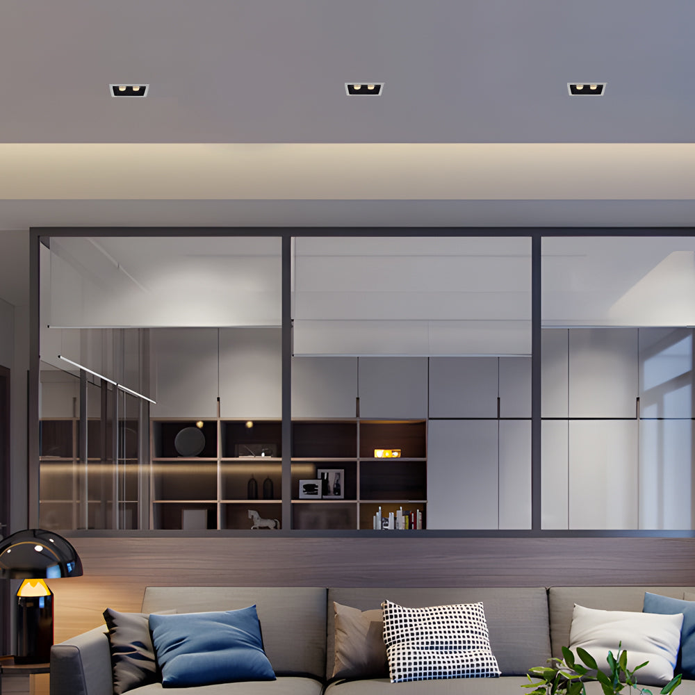 Linear recessed ceiling spot lights integrated into modern open-plan living space.
