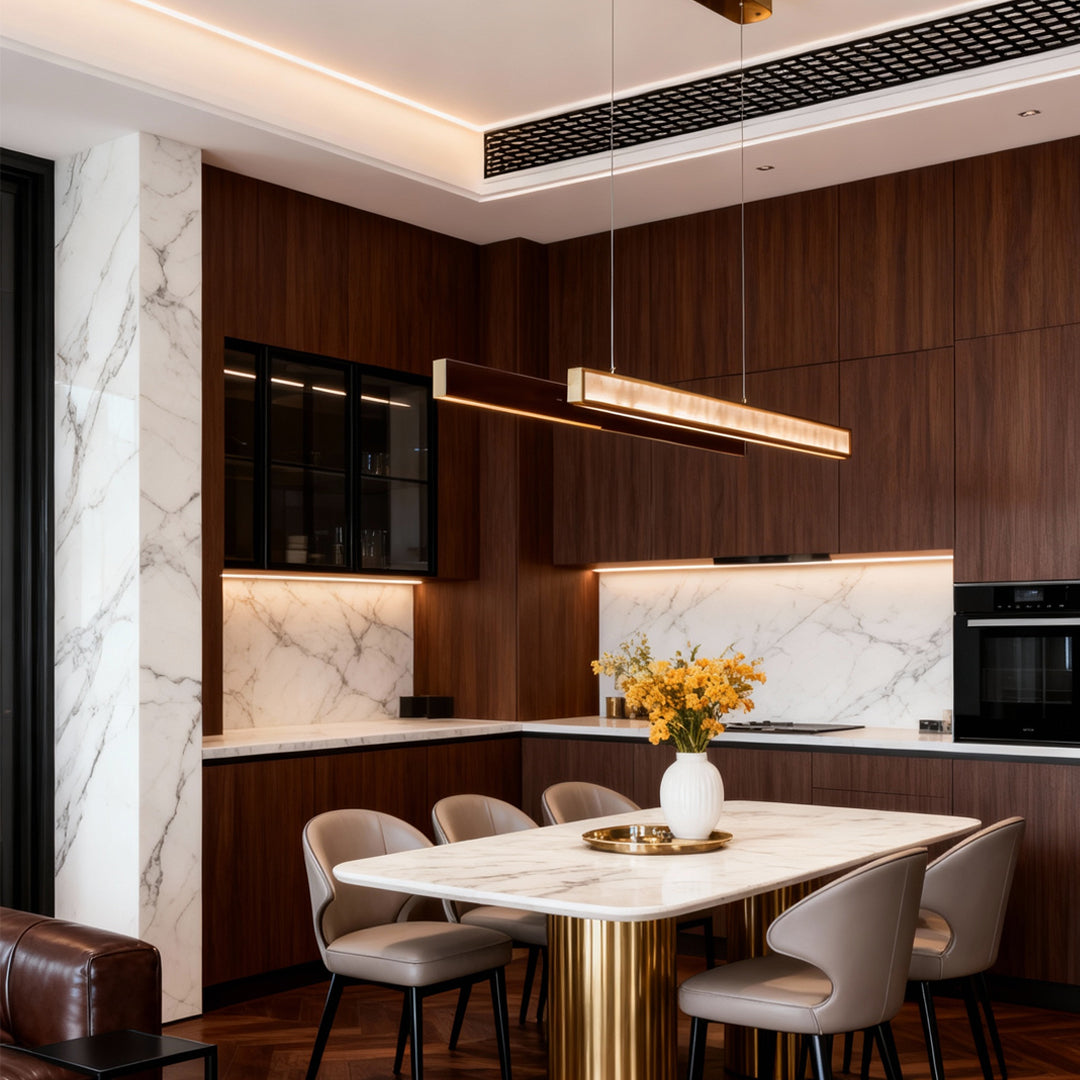 Gold linear suspension light installed above a marble dining table in a modern dining room.