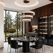 Sophisticated dining area with multi-layer linear suspension light fixtures in a modern luxury style.