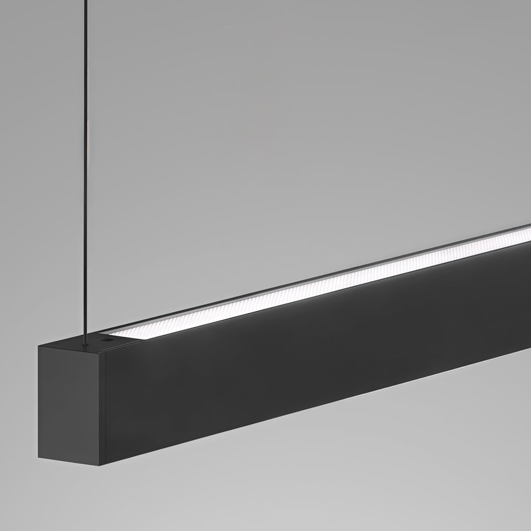 Close-up detail of black linear suspension light with integrated LED diffuser.