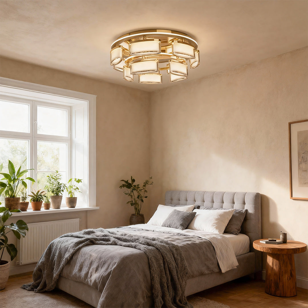 Linear suspension lighting mounted on ceiling in bright bedroom with natural light and botanical accents