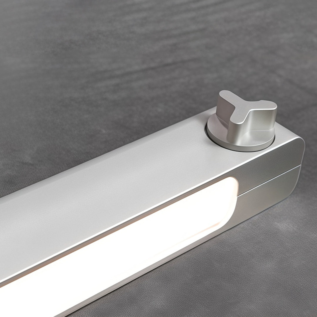 Detailed view of modern linear suspension lighting fixtures with integrated LED diffuser and mounting hardware.