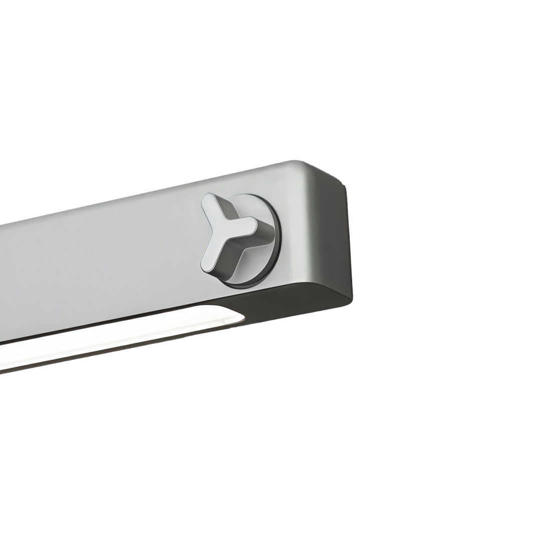 Close-up detail of linear suspension lighting fixtures featuring sleek rounded edge aluminum housing.