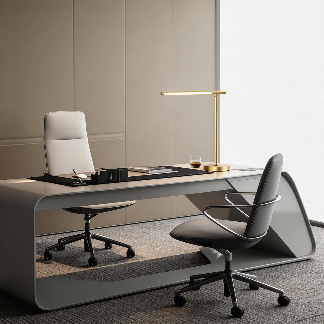Linear table light with a gold finish, enhancing a contemporary office desk.