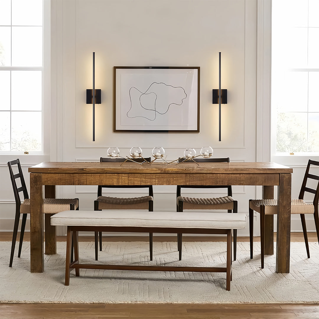 Linear wall lights above a dining table, providing focused and stylish lighting for family gatherings.