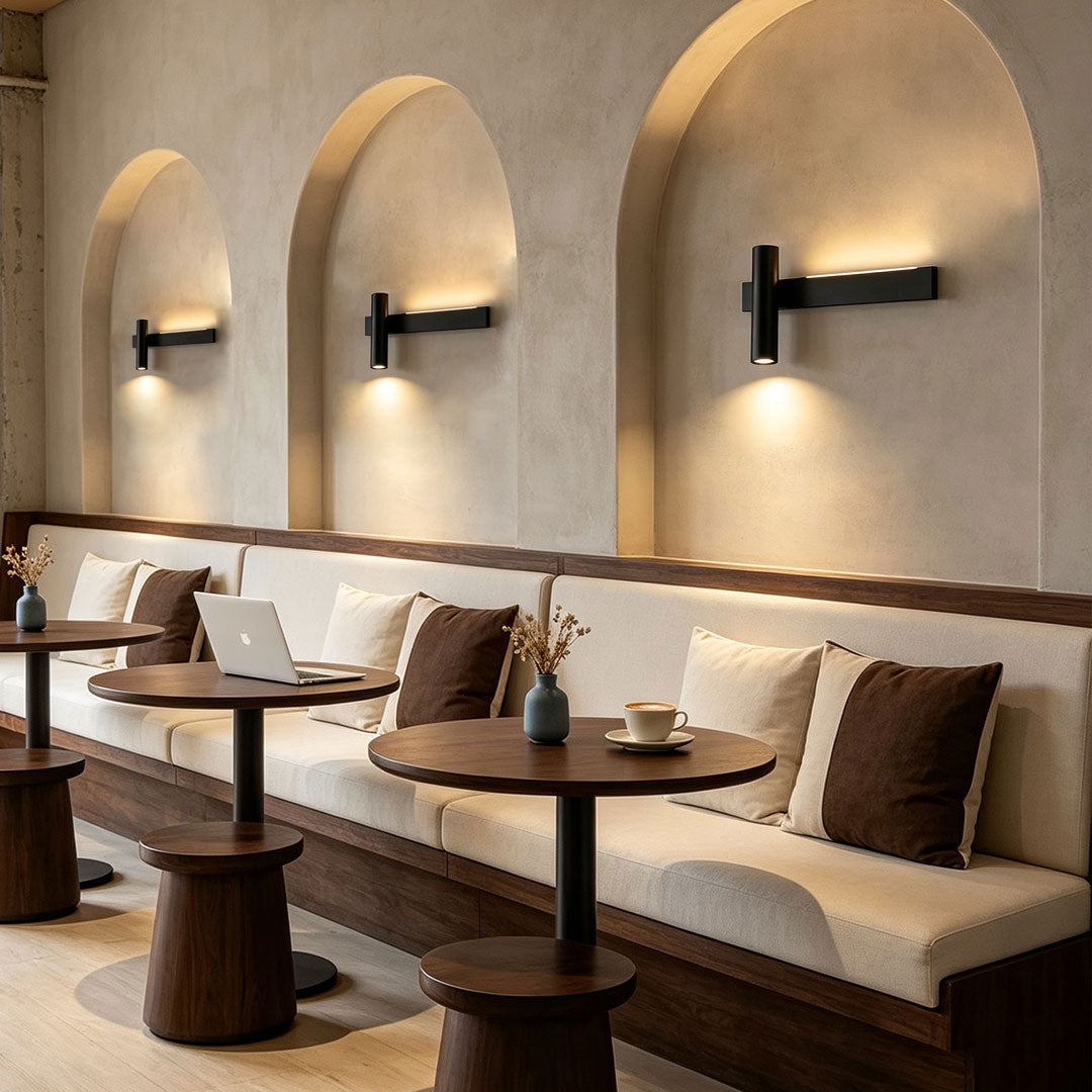 Stylish linear wall sconces enhancing restaurant seating area with soft ambient illumination and arched walls.