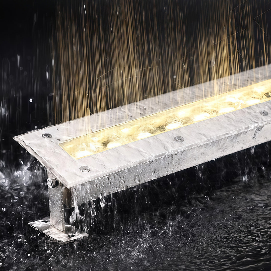 LED linear wall washer light under running water for waterproof testing.