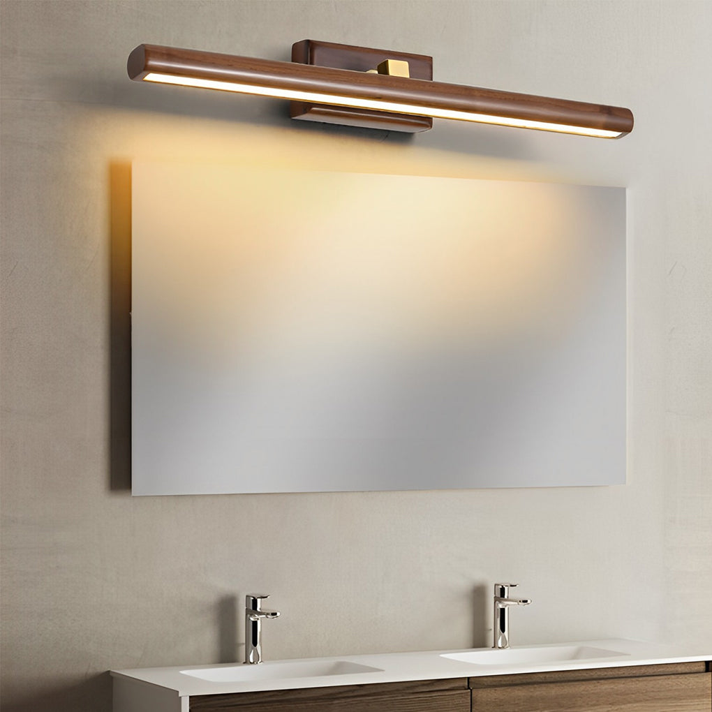 Linear wood vanity light mounted above a rectangular bathroom mirror.