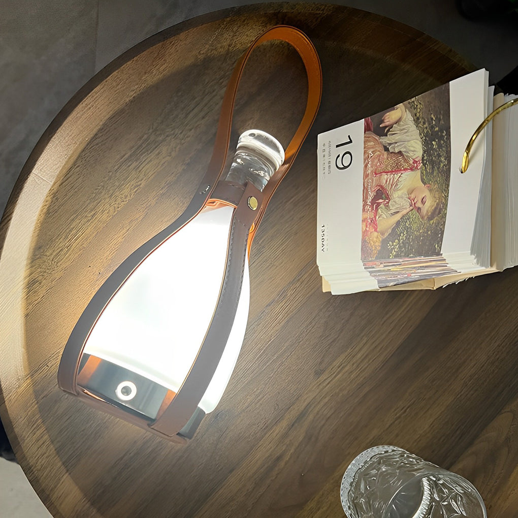 Liquor bottle lights with a modern design, illuminating a wooden desk with books.