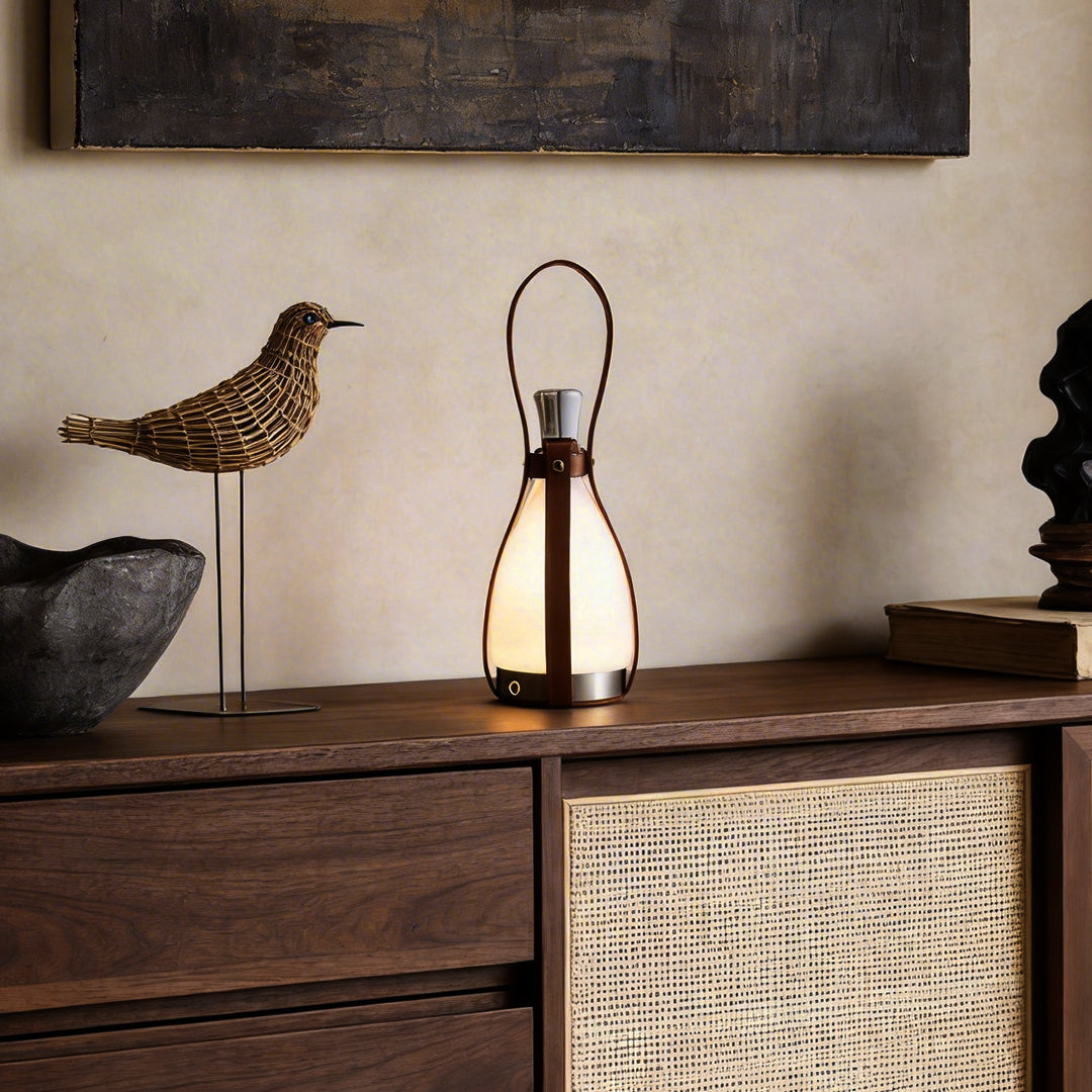 Liquor bottle lights with a rustic design, placed beside a decorative bird sculpture.