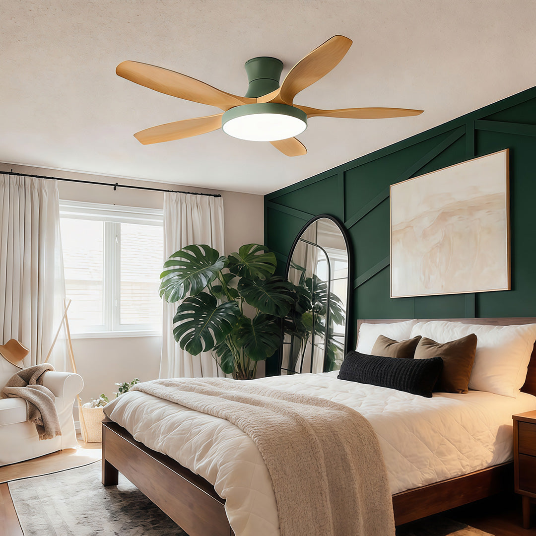 Modern living room ceiling fan with lights installed above a cozy bedroom-style living space, blending wood blades with warm ambient lighting.