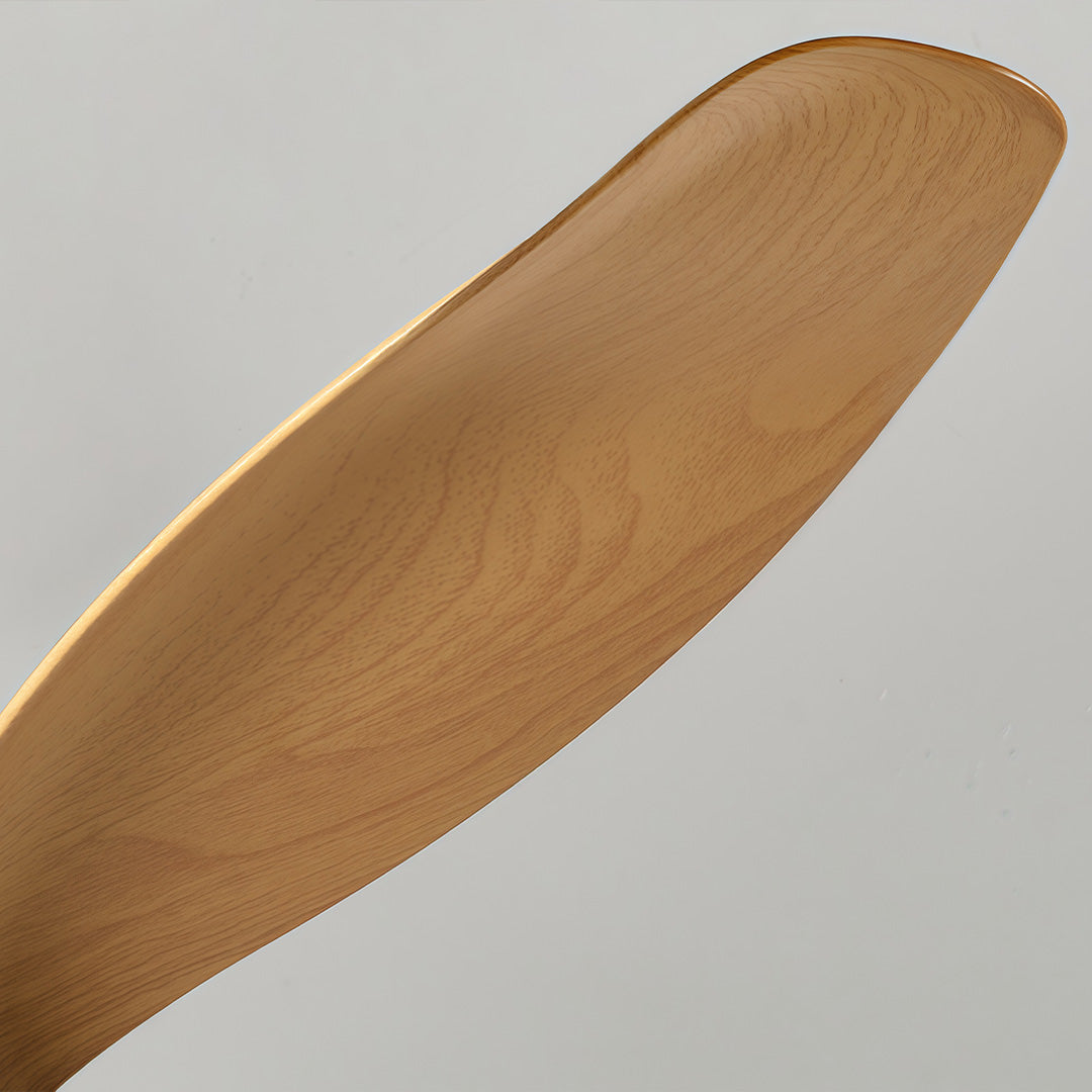 Detailed view of a wooden blade on a living room ceiling fan with lights, highlighting natural texture and curved blade shape.