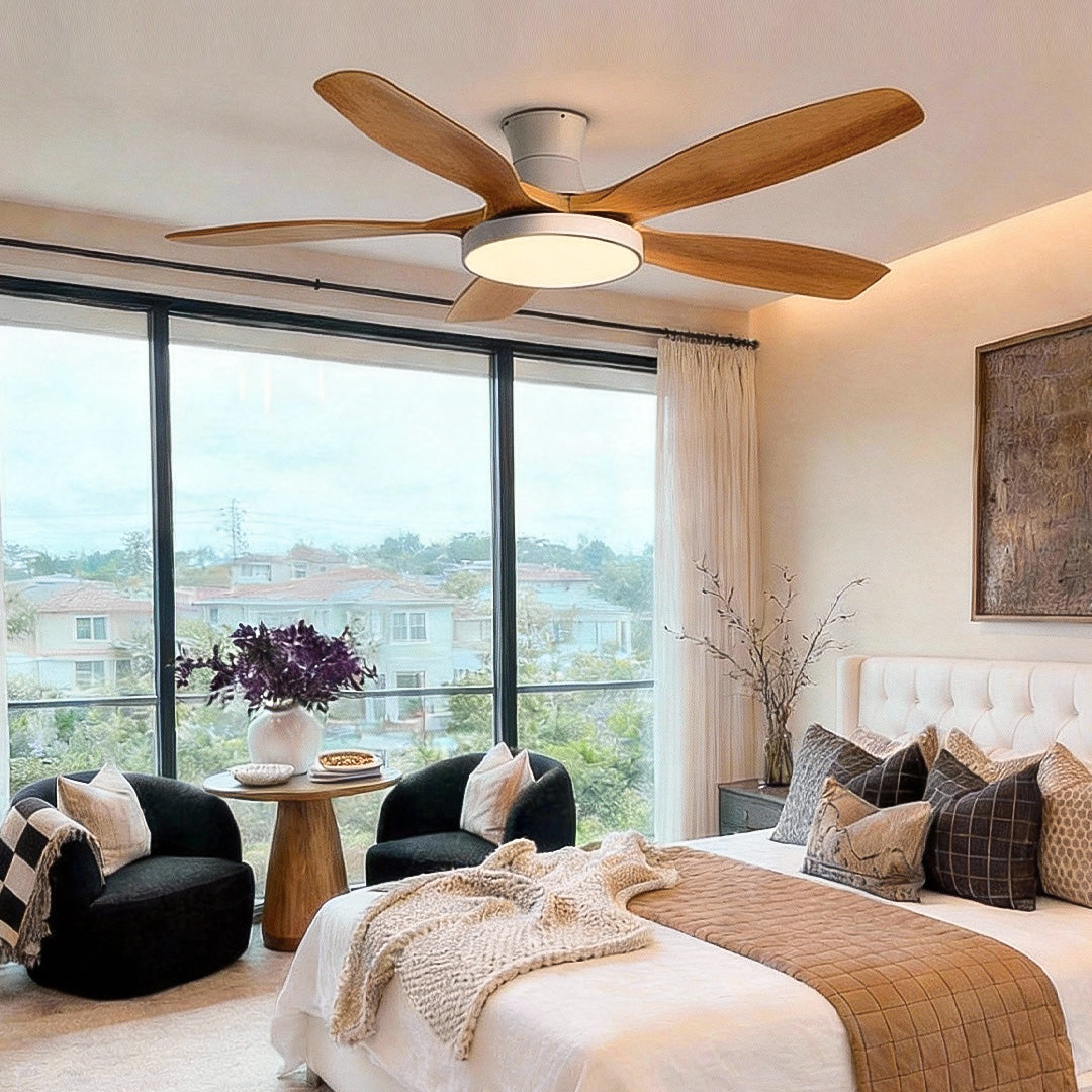 Living room ceiling fan with lights centered in a bright living area, featuring natural wood blades and a soft integrated LED light.