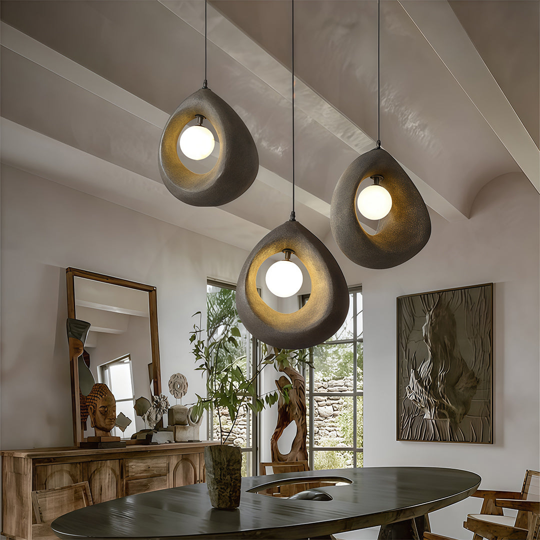 Cluster of statement pendant light illuminating a stylish living area with artistic decor.