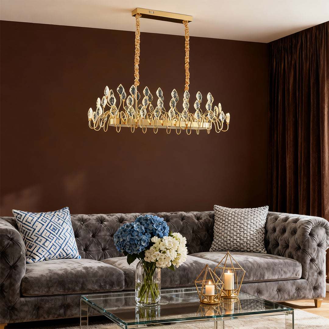 Crystal gold LED chandelier hanging above a modern living room.