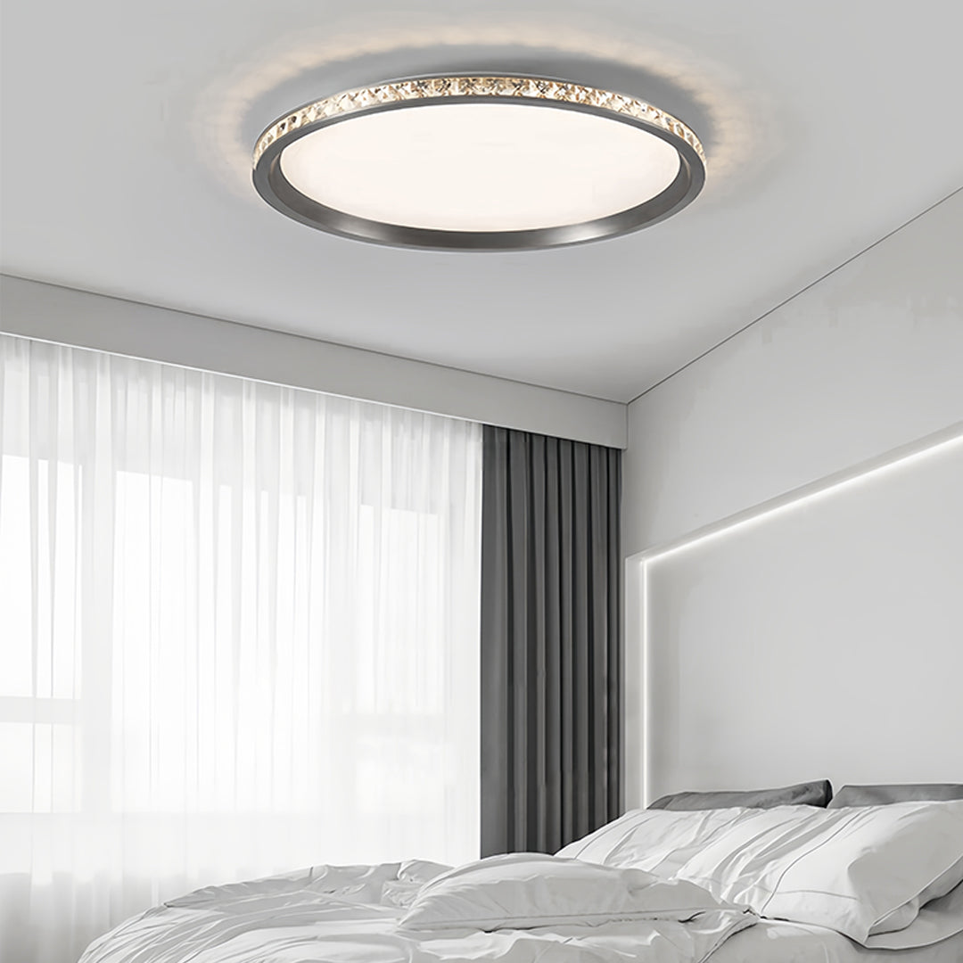 Round flush mount LED light mounted in elegant living room with white curtains and modern decor