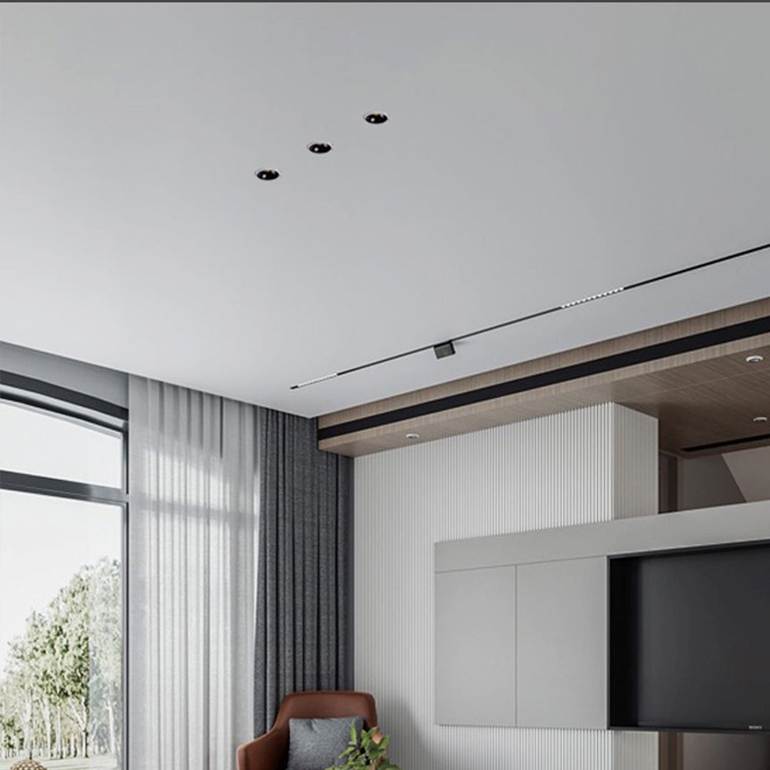 Modern living room with recessed ceiling round led lights providing ambient illumination throughout space
