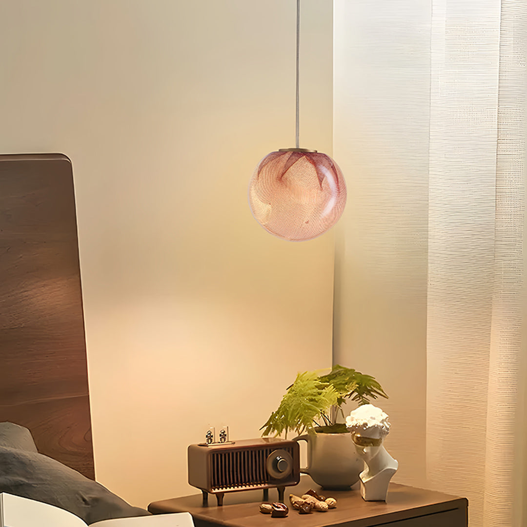 Designer glass globe pendant lights with rose gold finish illuminating living room with warm ambient glow and modern appeal