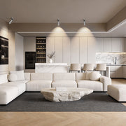 Modern living room with spotlight light fixture on ceiling illuminating the seating area.