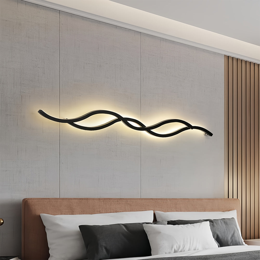Long creative bedside wall light installed above the headboard, enhancing the aesthetic of a contemporary room.