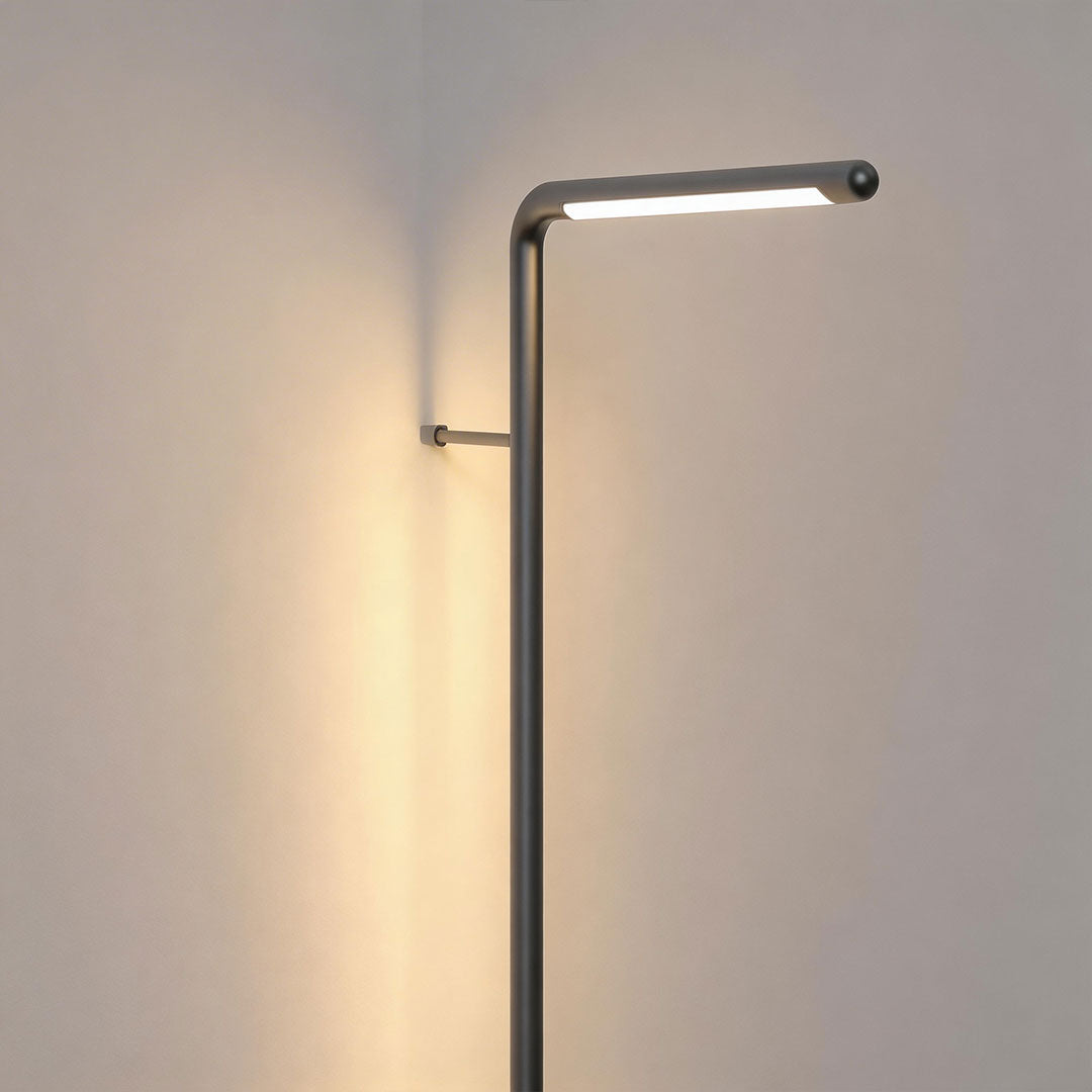 Long outdoor wall lights with a modern linear design, enhancing a stone wall exterior.