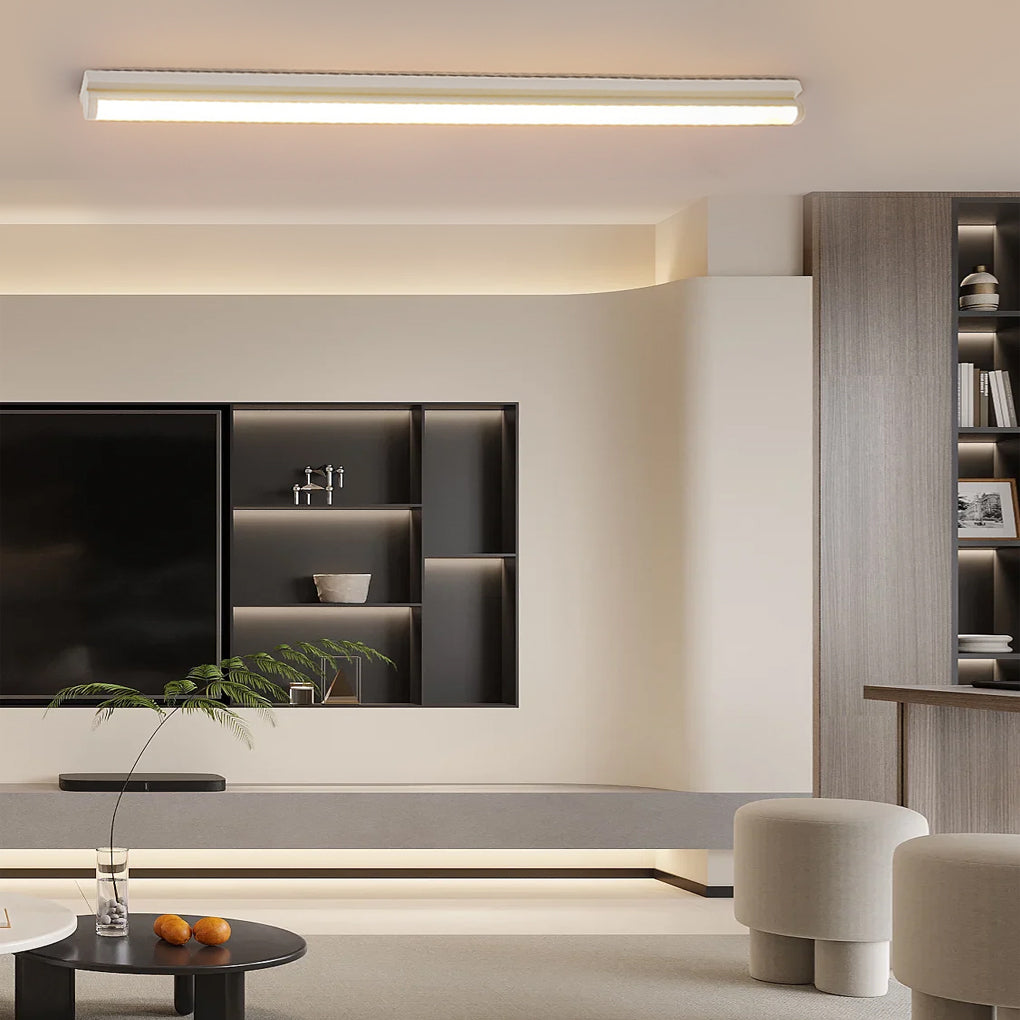 Long strip ceiling light providing ambient lighting in a stylish living room.