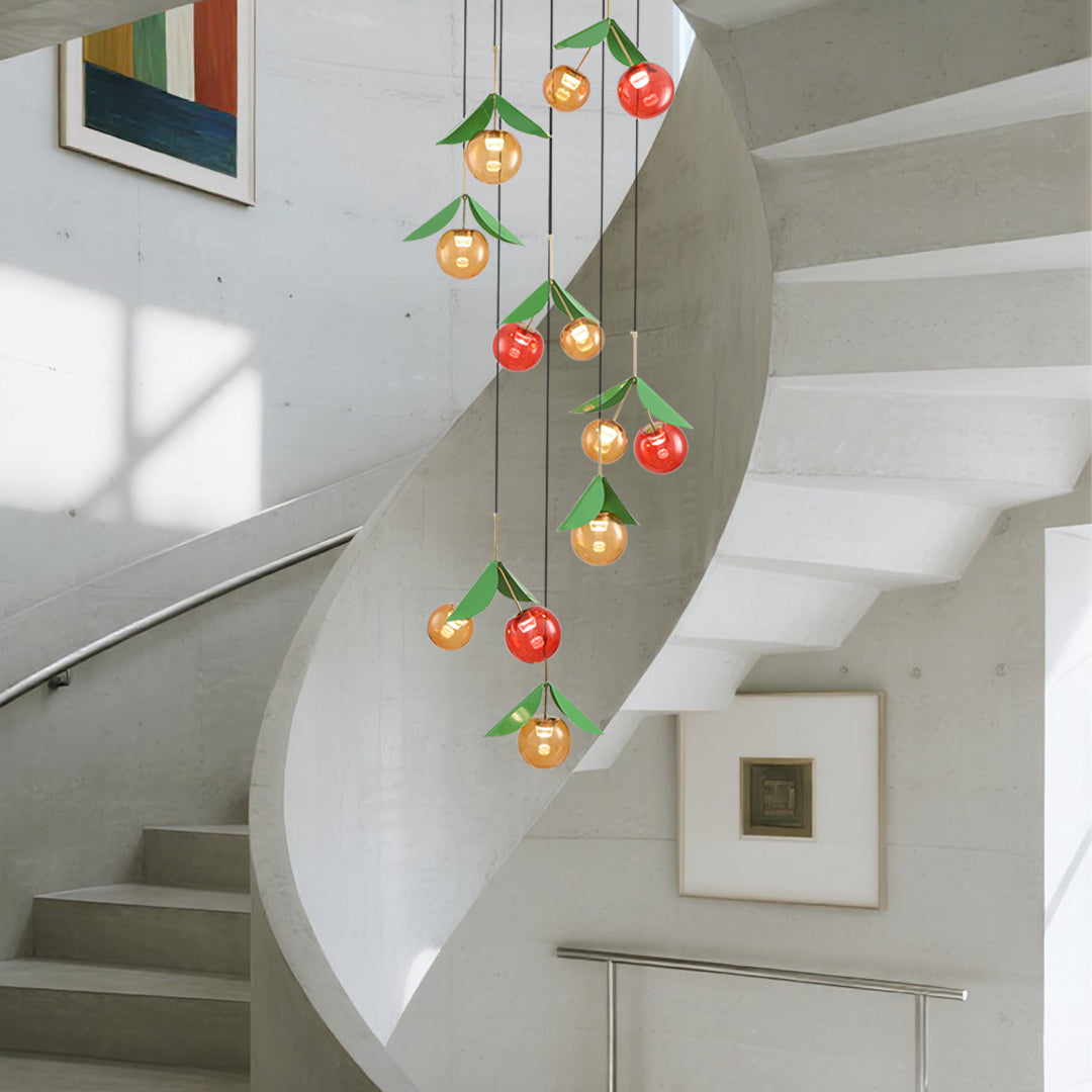 Long vertical cherry pendant light featuring multiple fruit-shaped glass orbs in red and golden tones