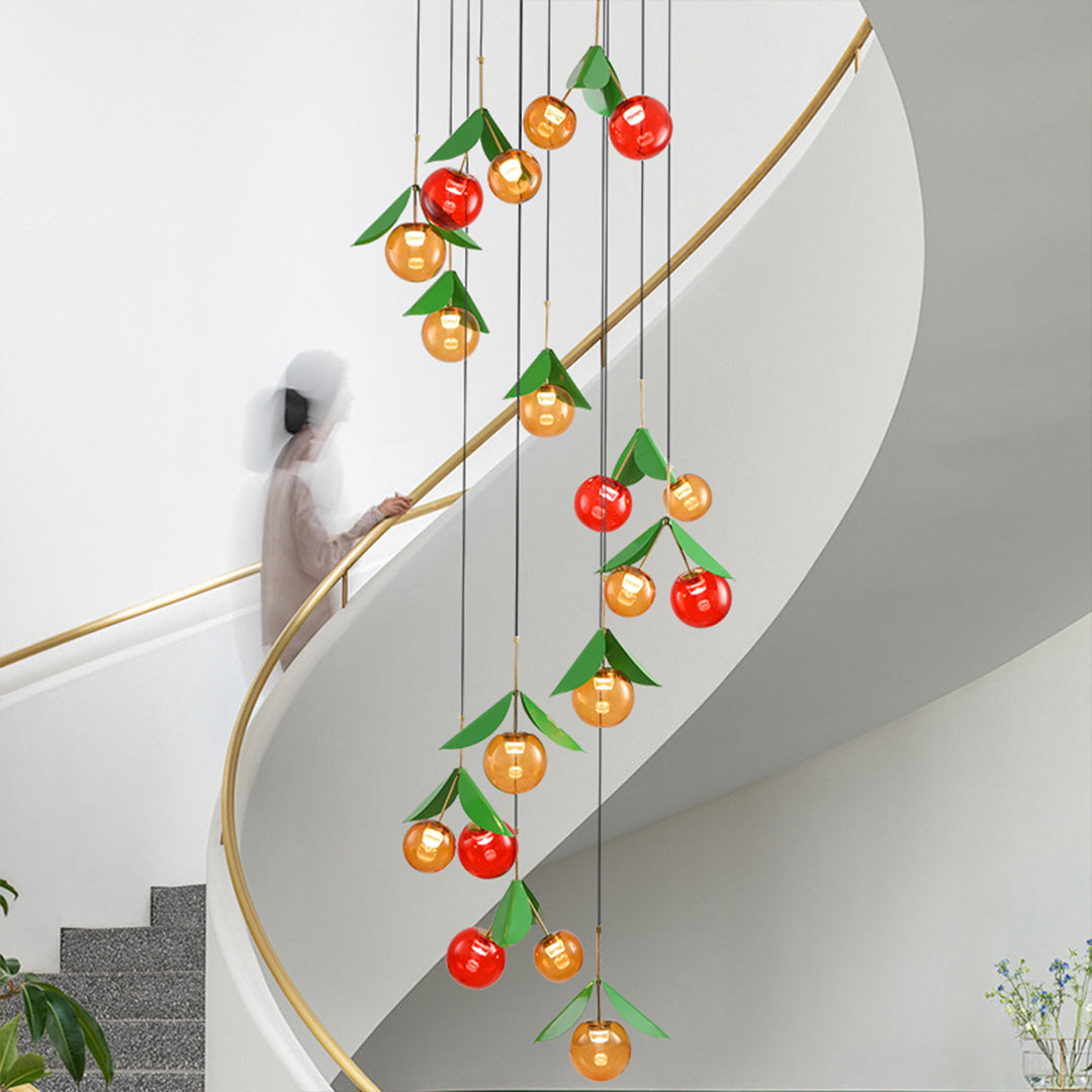 Long vertical cherry pendant light featuring multiple fruit-shaped glass orbs in red and golden tones