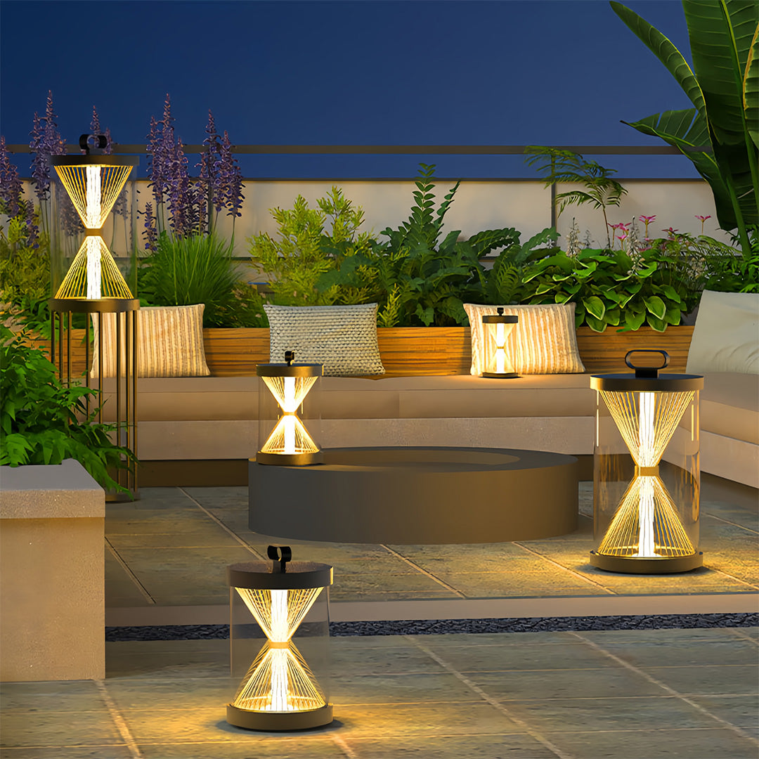 Low-profile black outdoor lantern fixtures placed on layered concrete planters, highlighting a vertical wooden accent wall.