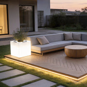 Luminous flower pots with a modern design, providing soft illumination on a patio.