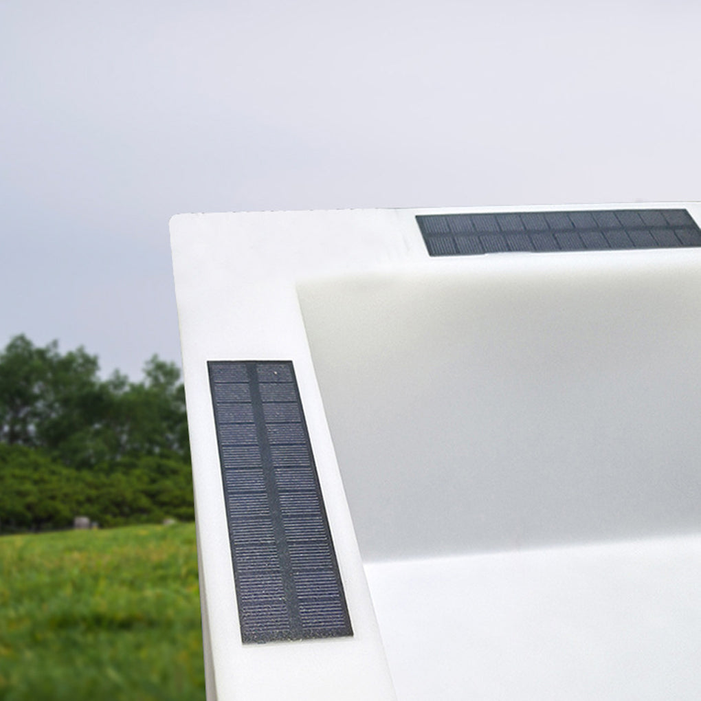 Luminous flower pots with a white finish, providing warm illumination near a pathway.