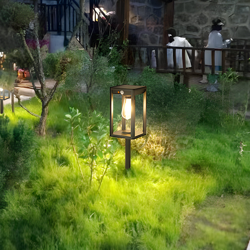 Lush garden landscape illuminated by strategically placed lantern lights creating magical evening atmosphere