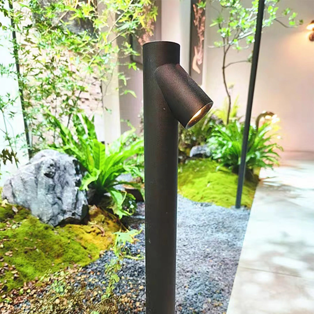 LED path light installed in lush garden landscaping providing elegant evening illumination among plants