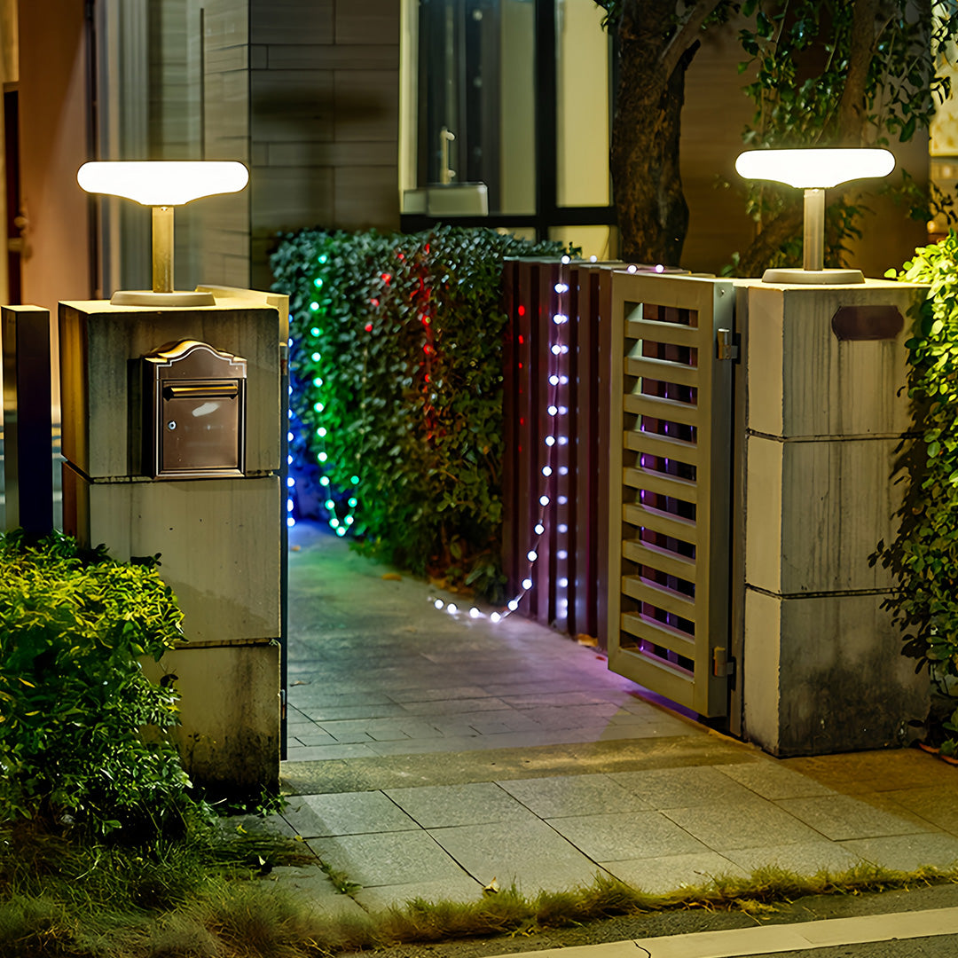 Solar LED post light in a lush garden, modern and eco-friendly outdoor lighting solution