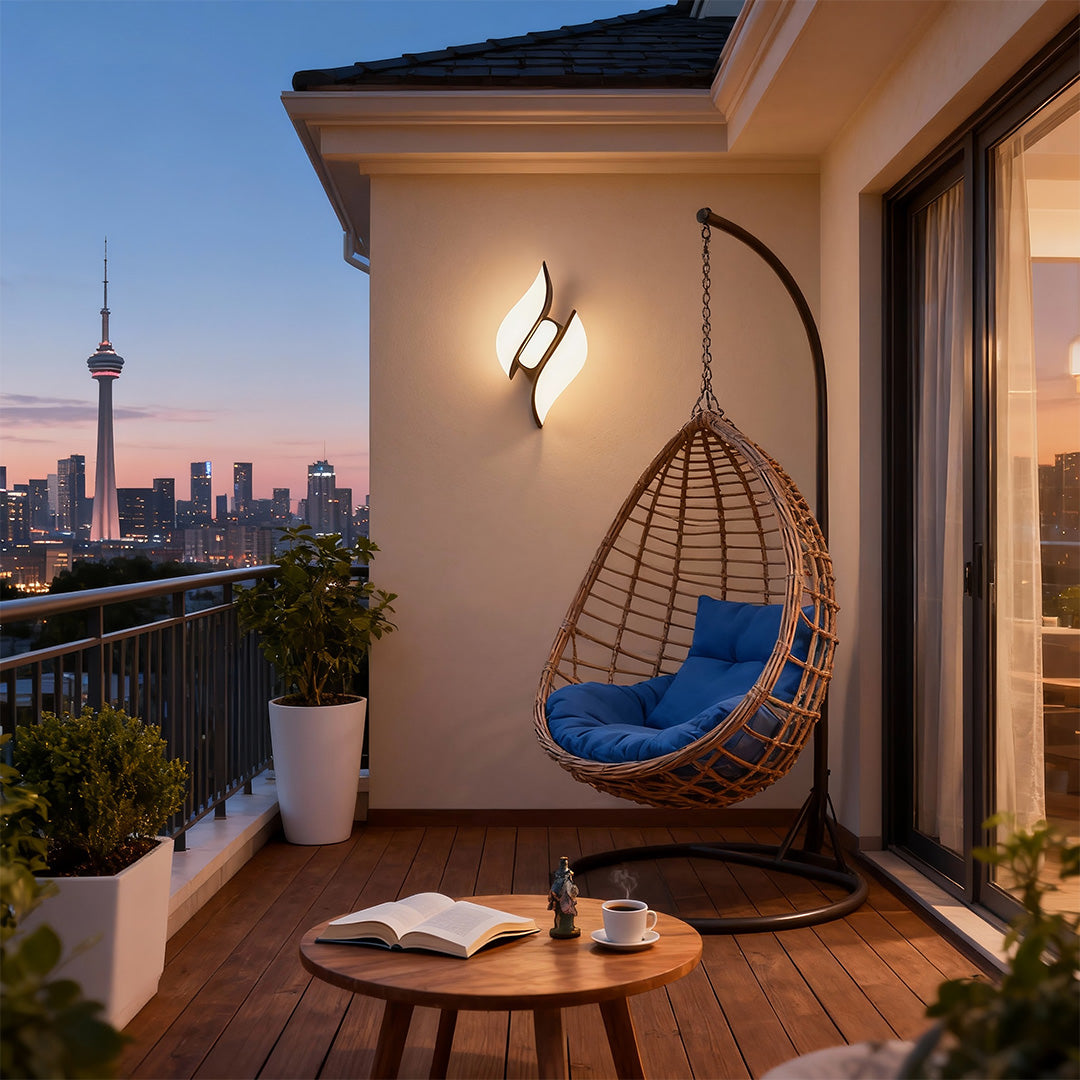 Luxurious black outdoor wall sconces featuring glass shade chandelier styling on covered terrace with city skyline view.