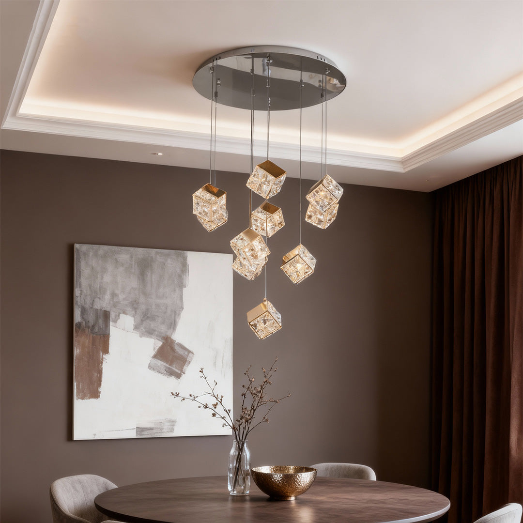 Luxurious chandelier with crystals and glass shade chandelier styling illuminating modern dining room with gray tones and abstract art.