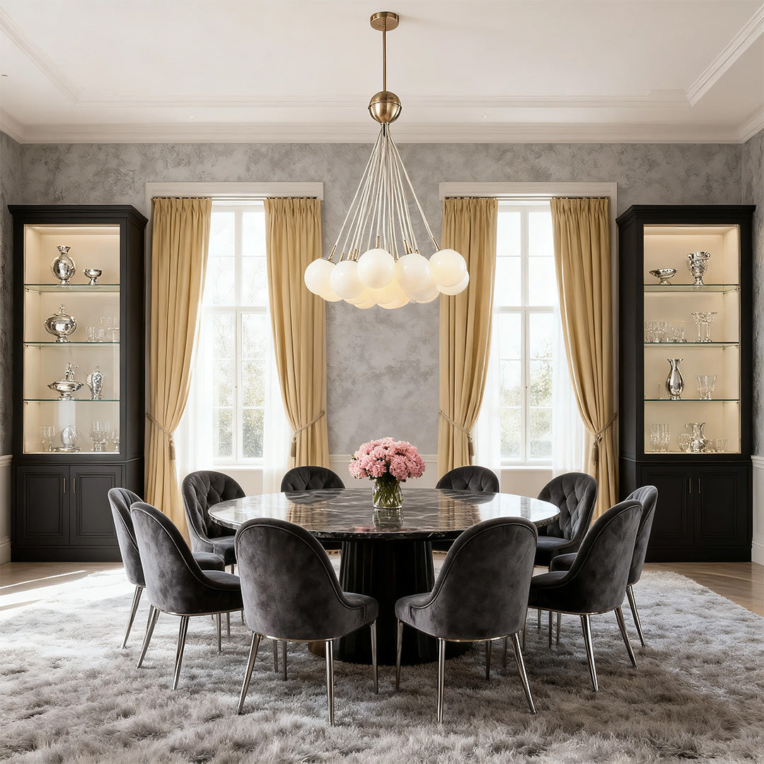 Luxurious cluster bubble glass chandelier with rose gold accents and multiple frosted orbs, centered above a velvet round dining table.