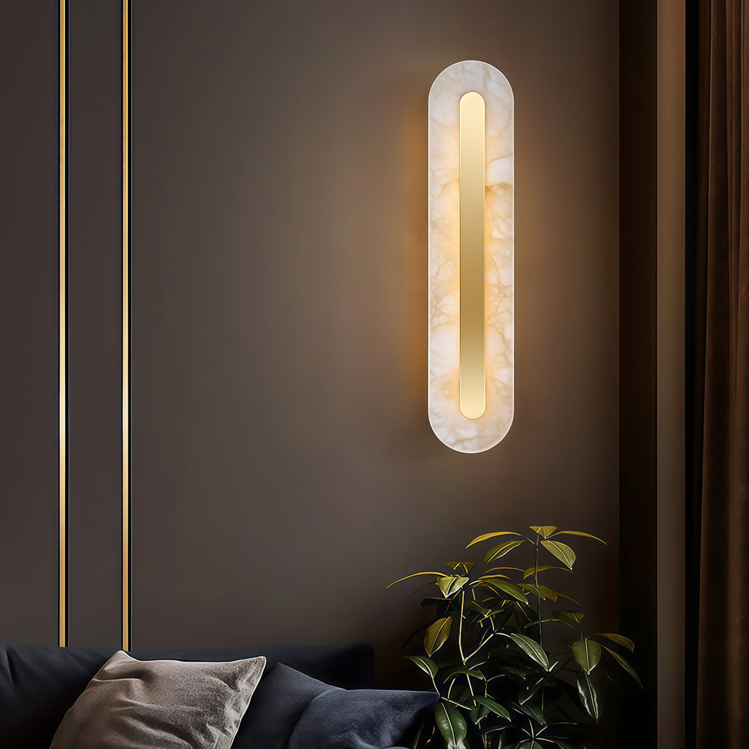 Luxurious gold wall light with glass shade chandelier styling creating warm ambient glow on dark bedroom wall with decorative accent.