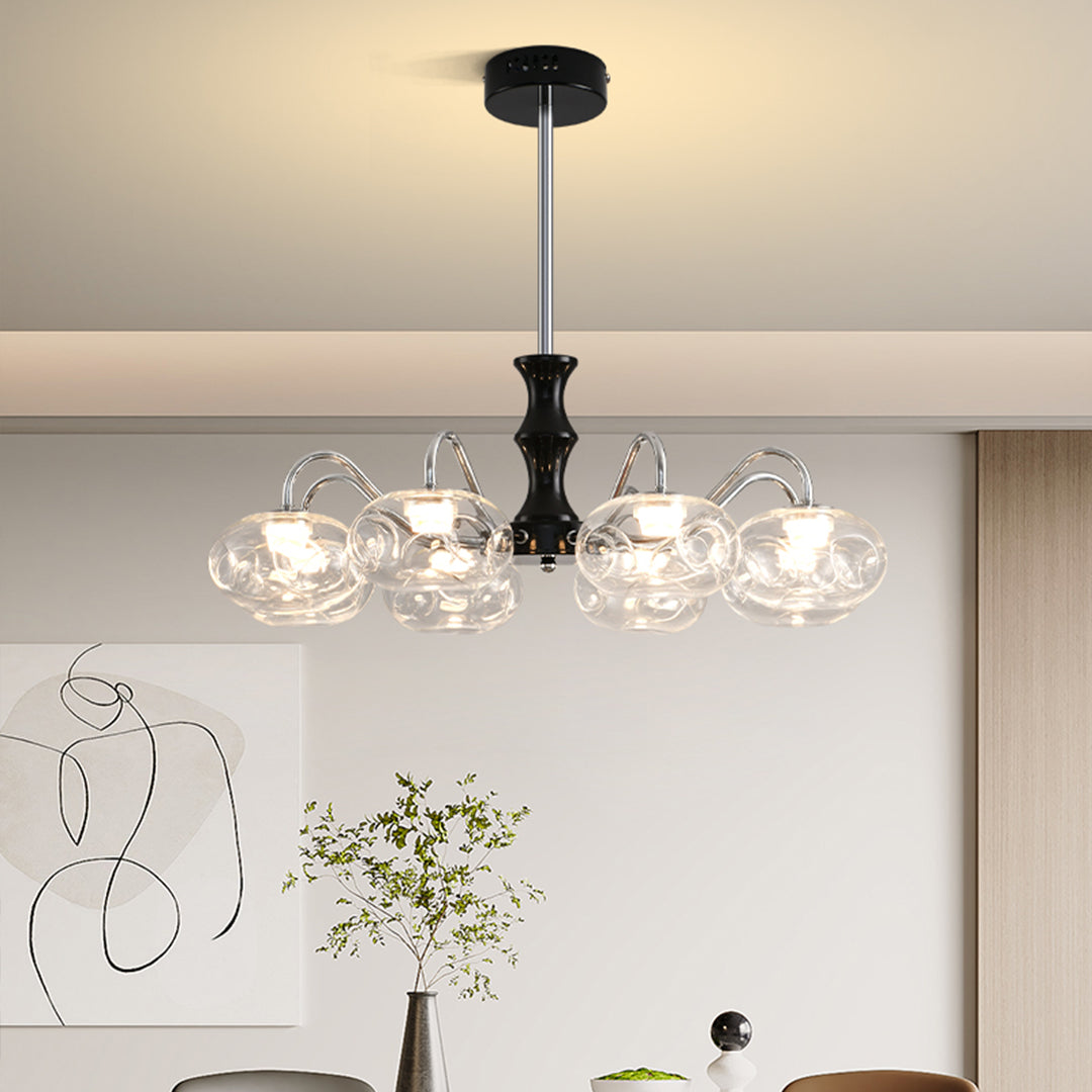 Luxurious art glass chandelier illuminating modern kitchen with warm ambient lighting and clear glass bulbs