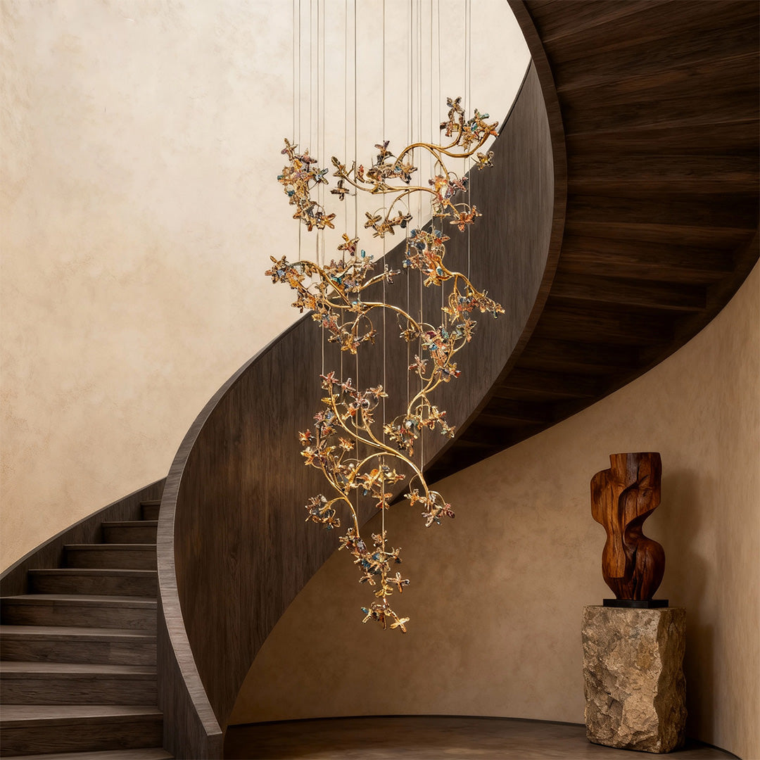 Luxurious modern staircase chandelier featuring glass shade chandelier influence creating stunning focal point beside spiral staircase with dark walls.
