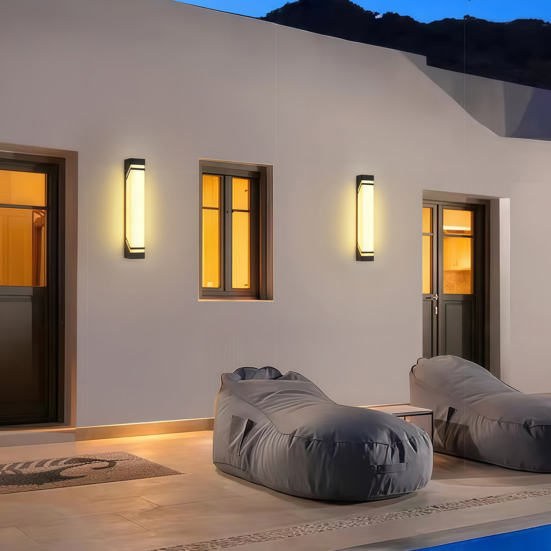 Luxurious wall mounted exterior lights featuring glass shade chandelier aesthetic creating warm lighting on white contemporary facade.