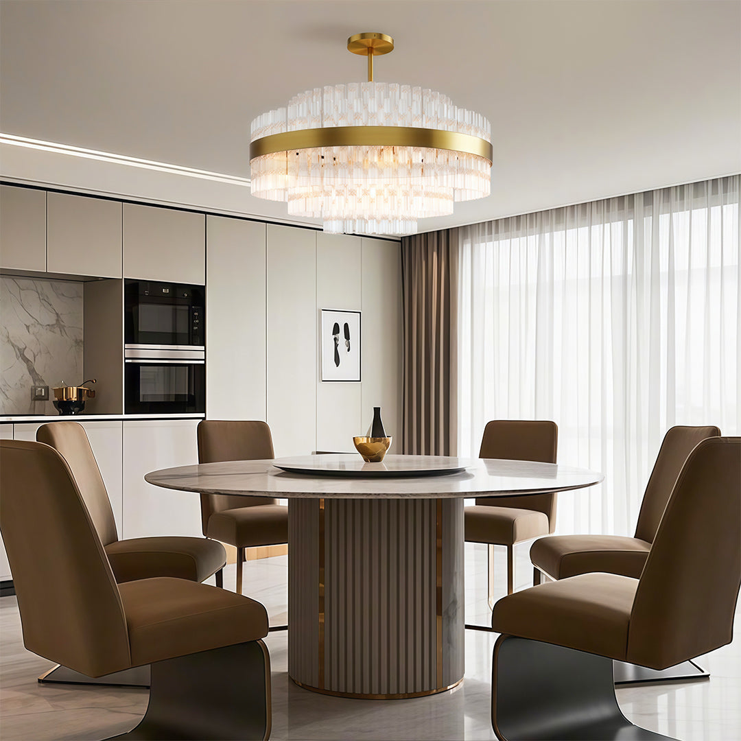 Modern luxury chandeliers above circular dining table in sophisticated neutral interior