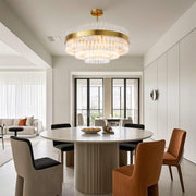 Modern luxury chandeliers enhancing contemporary dining space with round wooden table