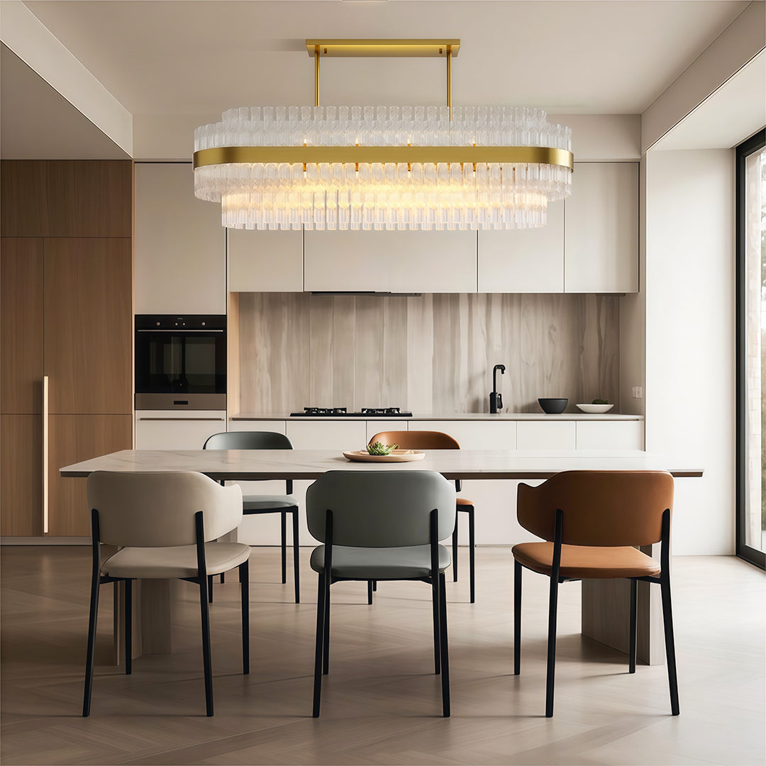 Modern luxury chandeliers illuminating elegant dining room with sleek kitchen backdrop