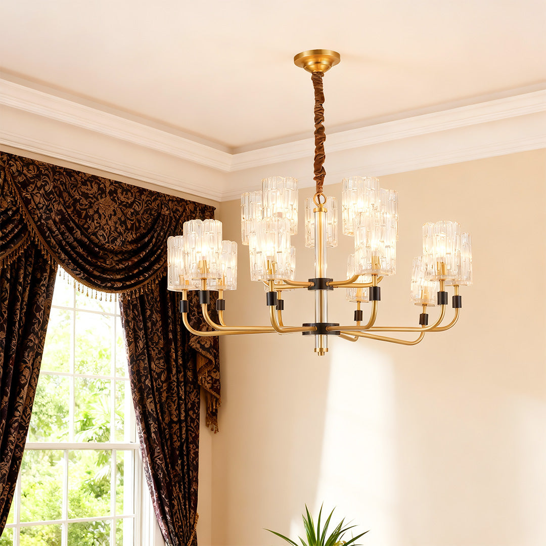 Modern luxury chandeliers illuminating elegant entryway with ornate curtains and greenery